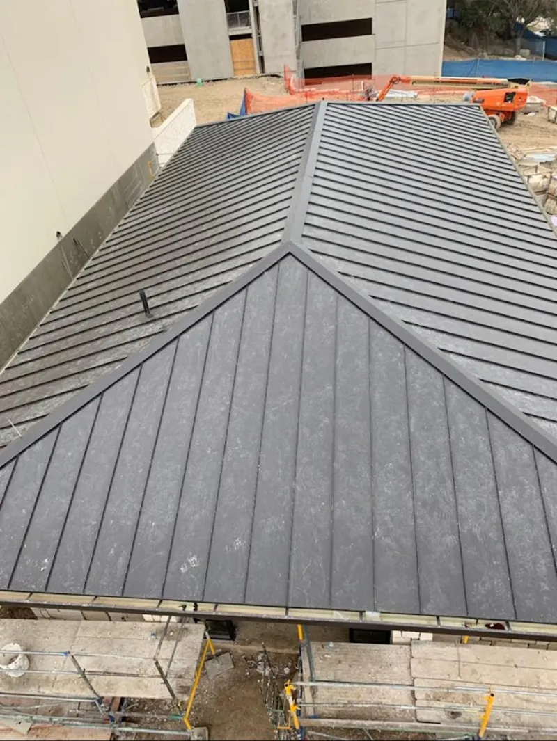 Commercial metal roof construction with crane equipment in College Place